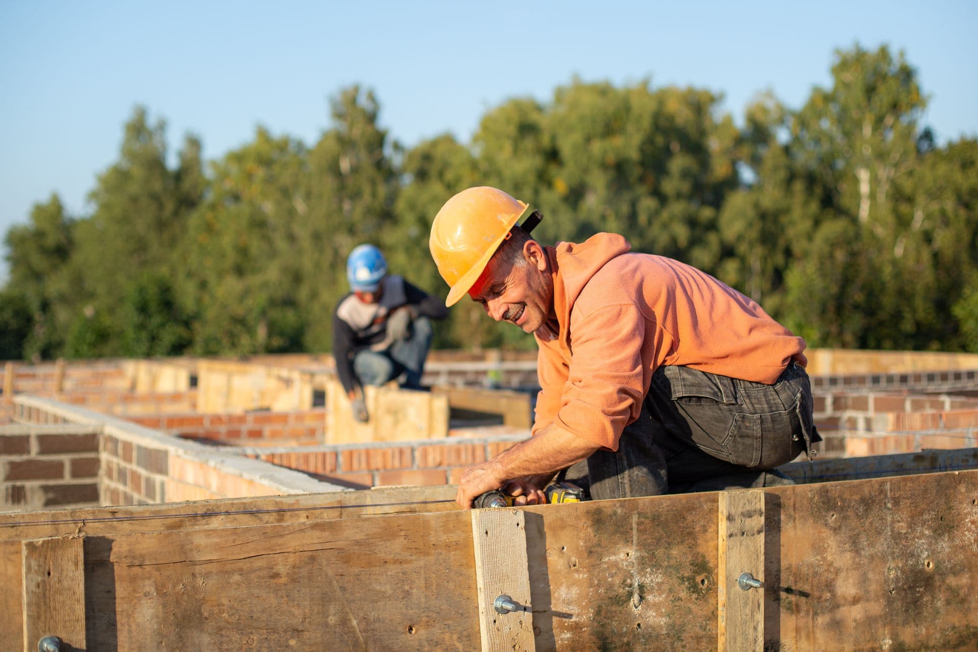 A contractor in a hard hat working on a construction site.