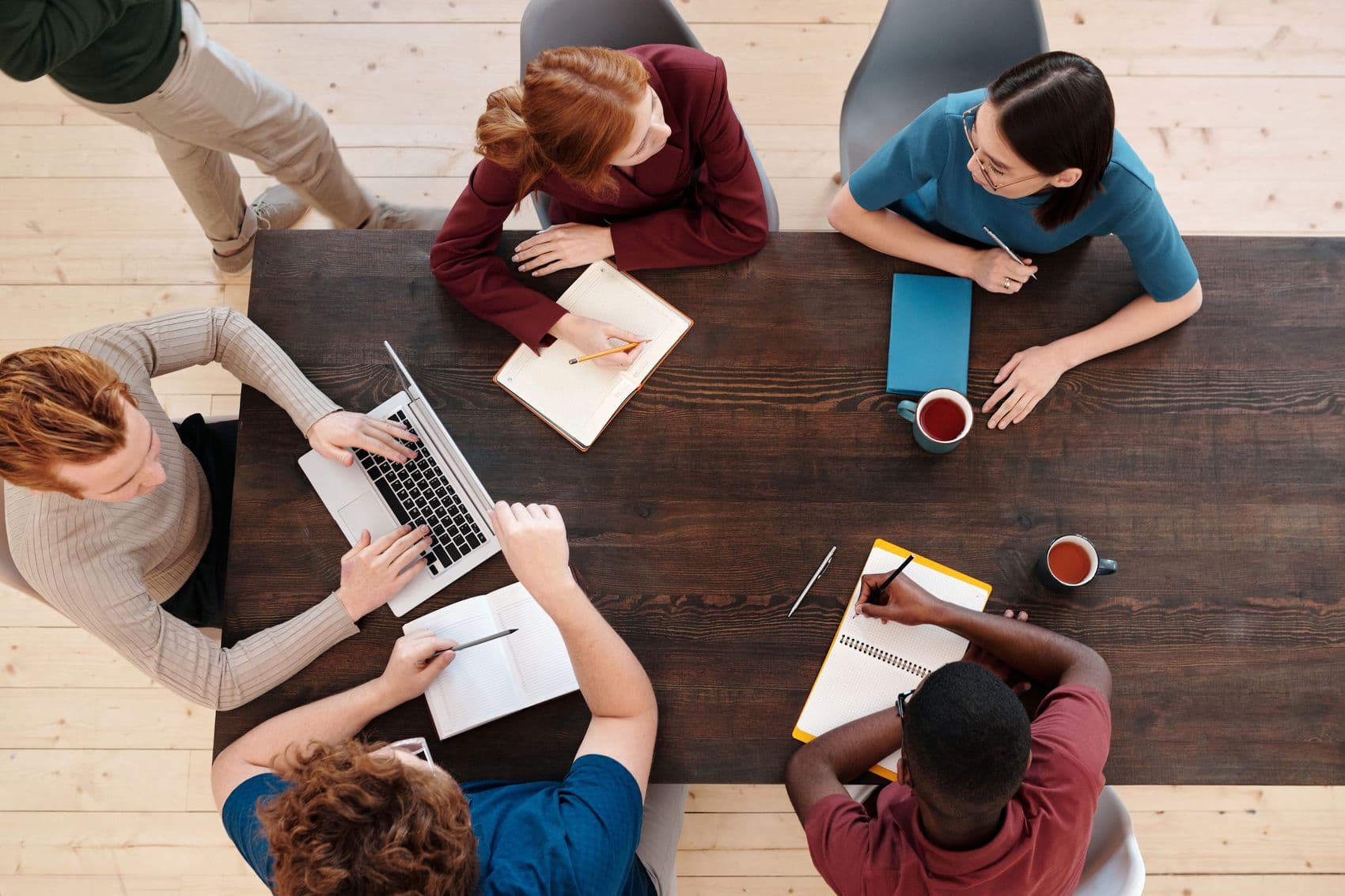 A financing team working through a client's file together around a meeting table.