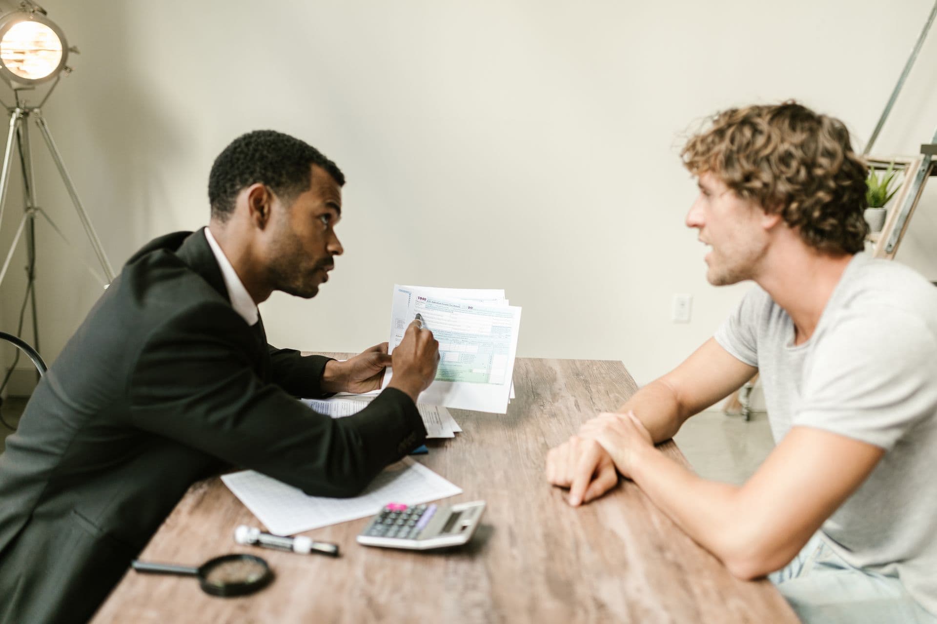 An advisor walking a business owner through paperwork across a desk.